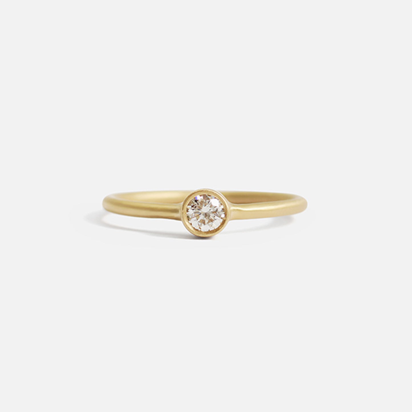 Details  Indulge in the timeless elegance of our Single Diamond Ring. This sparkling centerpiece features exquisite craftsmanship that will captivate your heart and dazzle on your finger. Elevate your style and make a statement with this stunning piece of jewelry.  3mm Round White Diamond Round Band 14k Yellow Gold Satin Finish WxT: 1.45mm