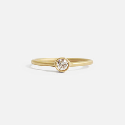 Details  Indulge in the timeless elegance of our Single Diamond Ring. This sparkling centerpiece features exquisite craftsmanship that will captivate your heart and dazzle on your finger. Elevate your style and make a statement with this stunning piece of jewelry.  3mm Round White Diamond Round Band 14k Yellow Gold Satin Finish WxT: 1.45mm